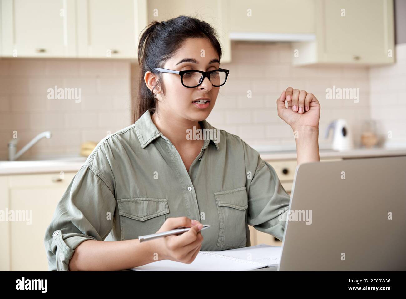 Indian woman teacher or student watching webinar or making video call. Stock Photo