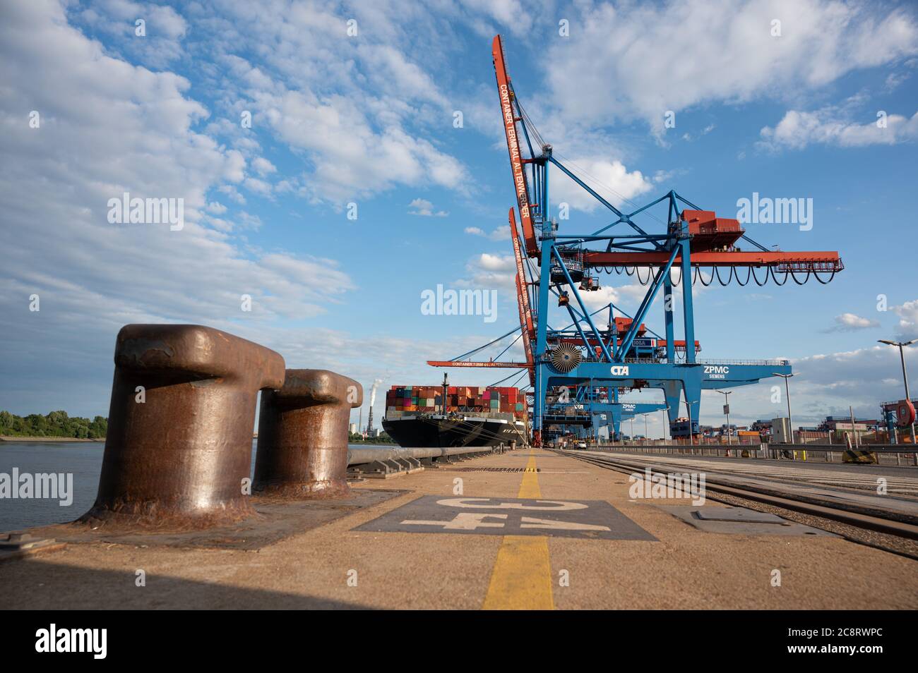 Hamburg, Germany. 16th July, 2020. A ship is loaded and unloaded at Container Terminal Altenwerder in the Port of Hamburg by container gantry cranes. Credit: Daniel Reinhardt/dpa/Alamy Live News Stock Photo