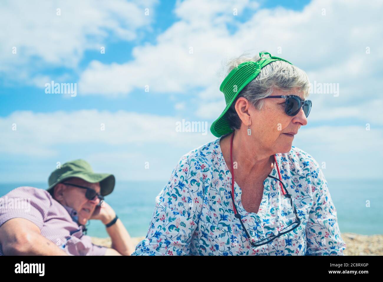 A senior couple are relaxing on the beach Stock Photo - Alamy