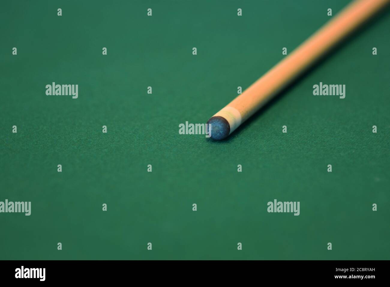 Pool cue on a green felt pool table Stock Photo