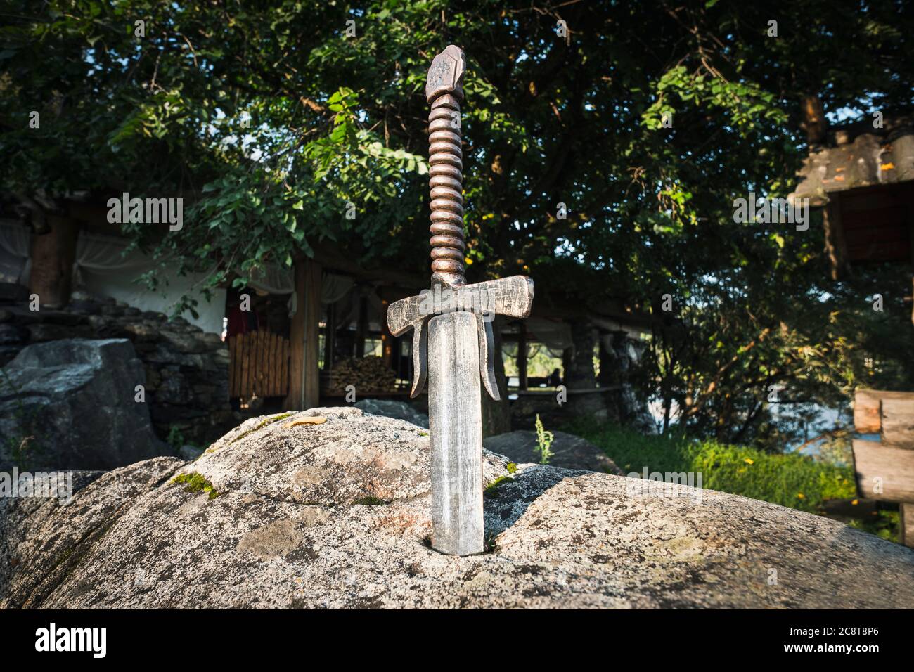 Excalibur, King Arthur's sword in stone. Edged weapons from the legend Pro king Arthur. Stock Photo