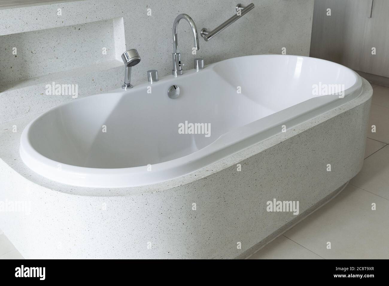 Close up of white bathtub in luxury modern bathroom. Stock Photo