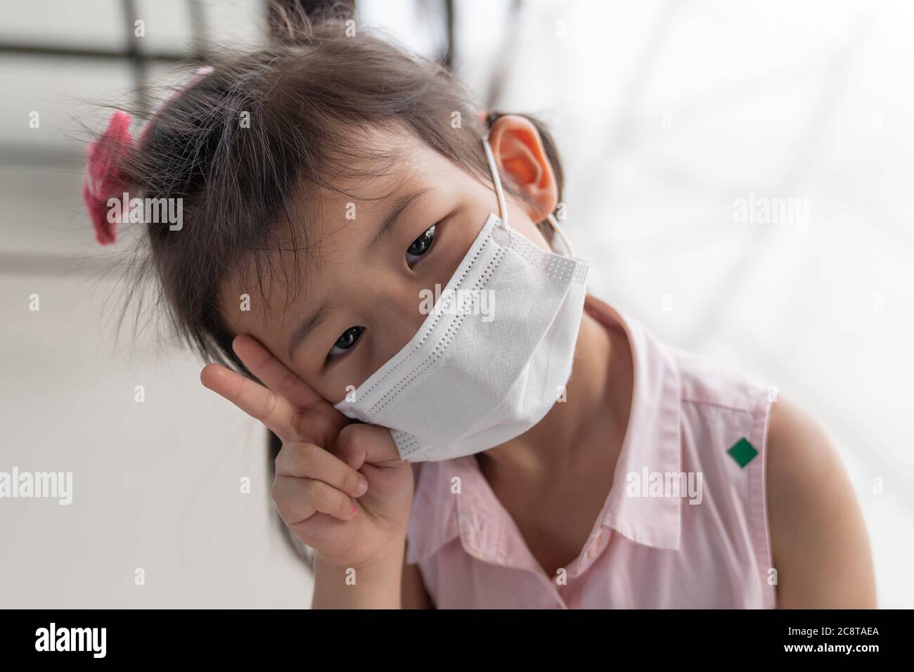 Asian child girl wearing a protection mask, to prevent virus infection or pollution. Stock Photo