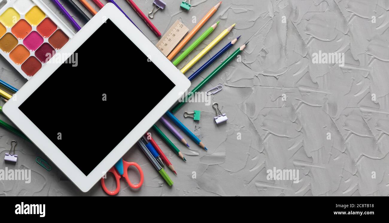 School supplies center composition on grey .concrete background Stock Photo