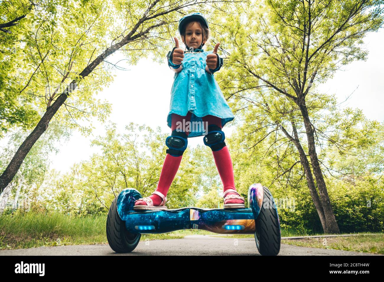 Girl rides on a modern board of self-balancing with a cat in forest in a  summer park. Active lifestyle. Electric scooter. Hover-board. New self  Stock Photo - Alamy