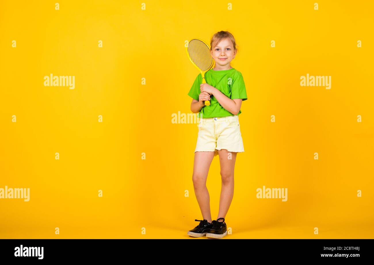 Tennis club for kids. Tennis player with racket. Childhood activity.  Fitness brings health and energy. Gym workout of teen girl. Sport game  success. Happy child play tennis. Tennis training Stock Photo -