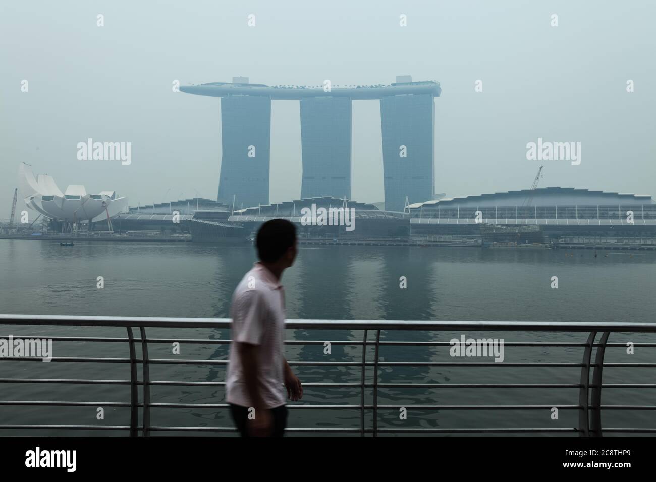 A man walked passed and checking out Marina Bay Sands engulf with air pollution. Singapore, Southeast Asia, Stock Photo