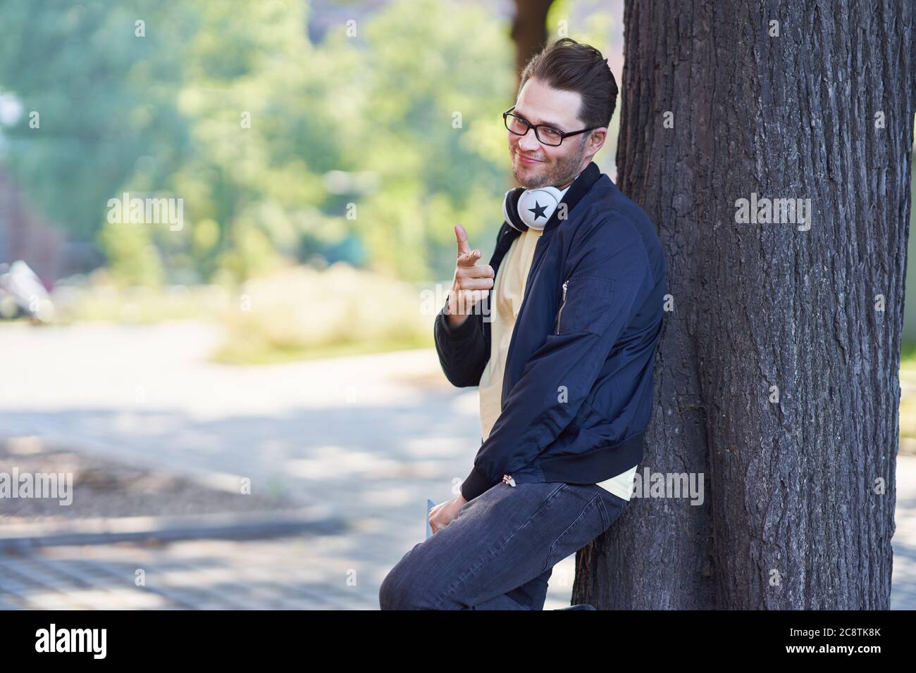 Male student in the campus studying outdoors Stock Photo