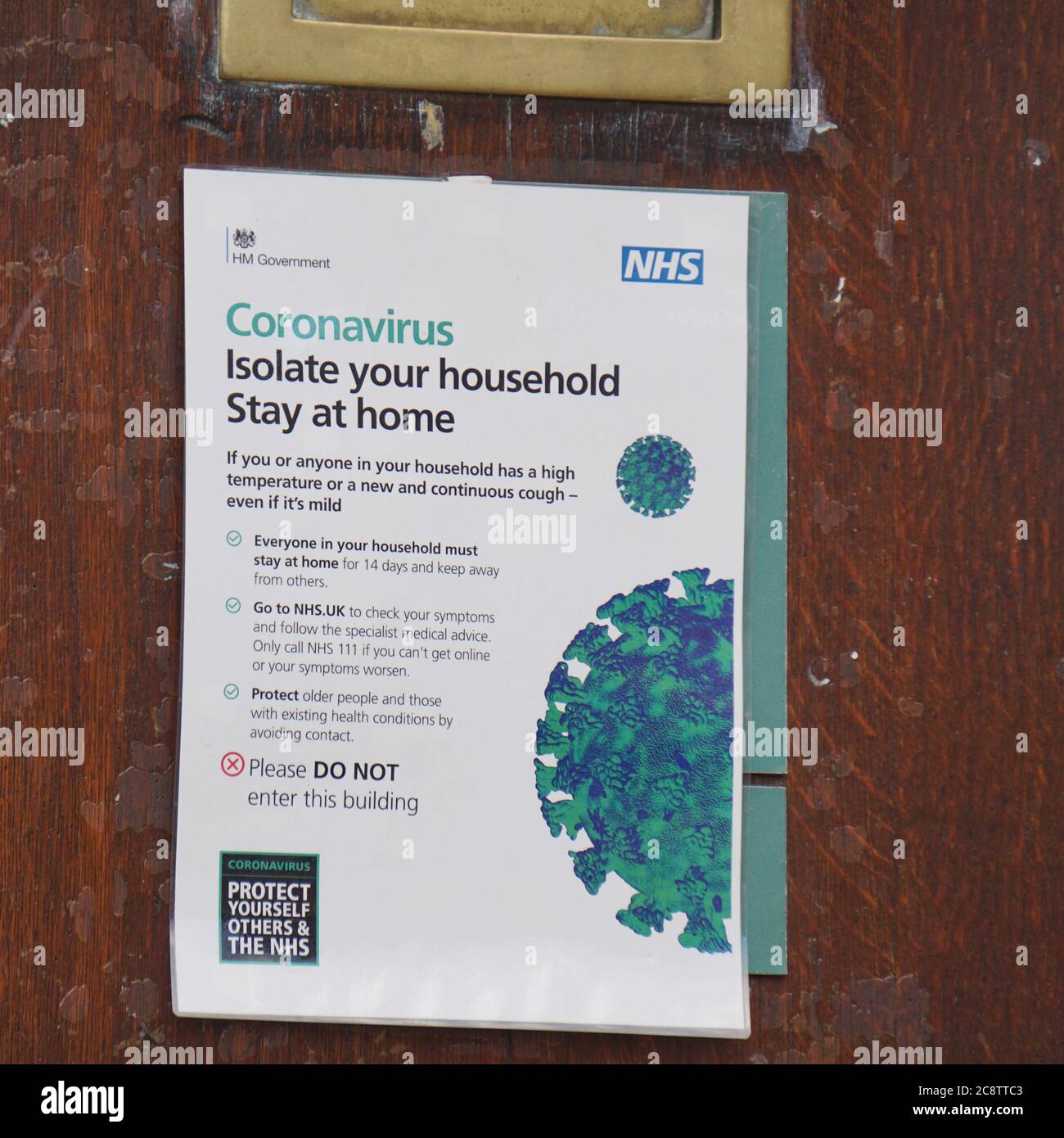 A NHS Coronavirus warning notice posted on the entrance door to the town hall in Henley-on-Thames, Oxfordshire, UK Stock Photo