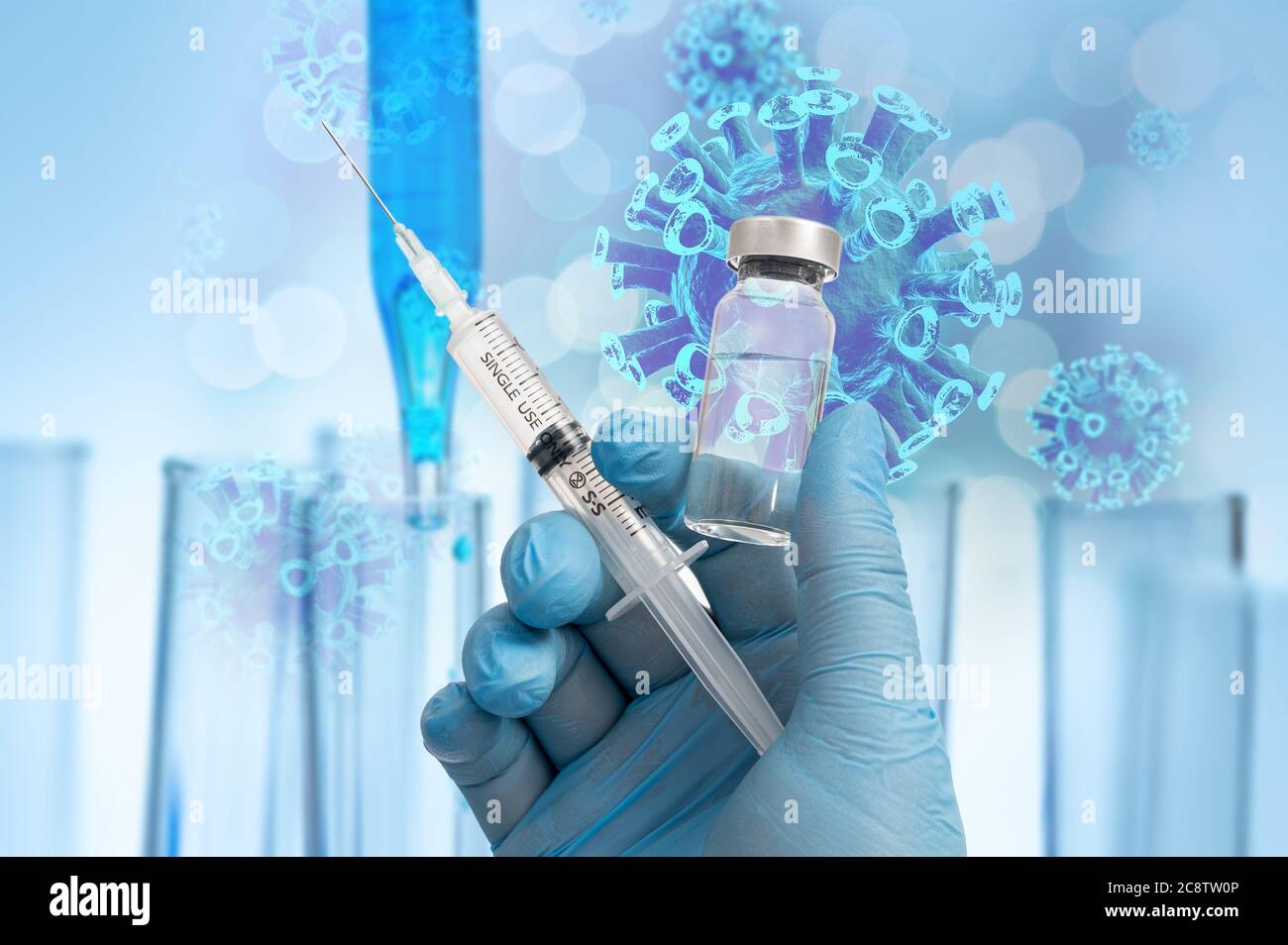 The scientist's hand holding the Covid-19 vaccine with blue gloves in the background of the biotechnology concept. Stock Photo