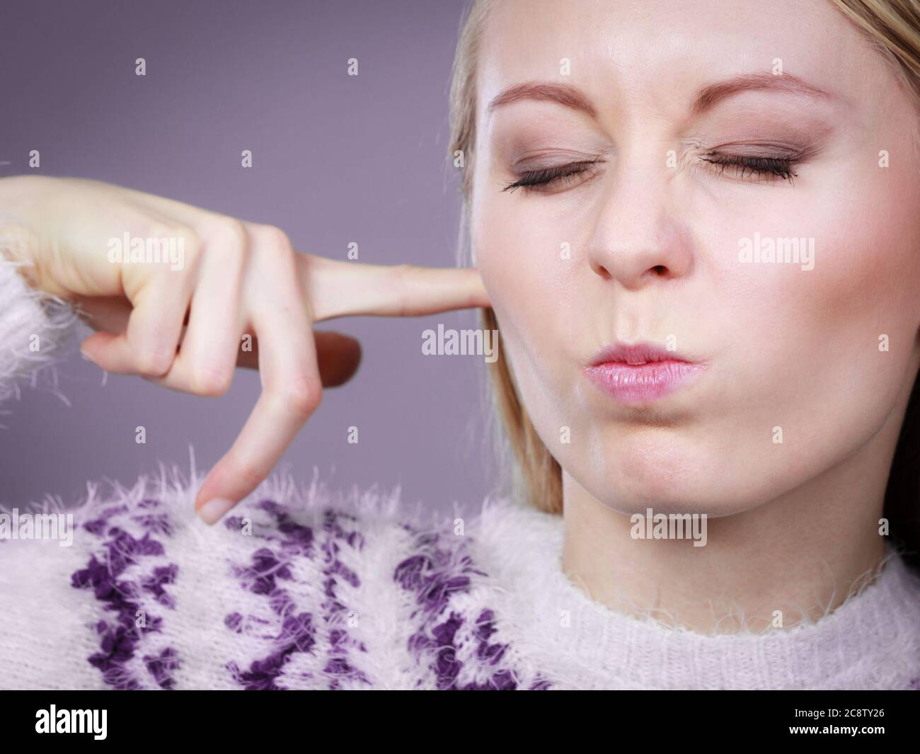 Hearing problems concept. Young blonde woman covering ears with her