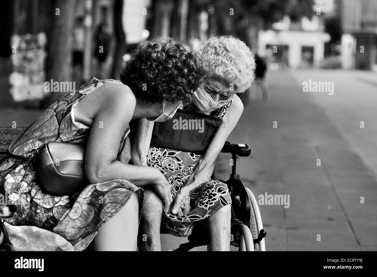 A woman comforts her frail, elderly mother, Barcelona, Spain. Stock Photo