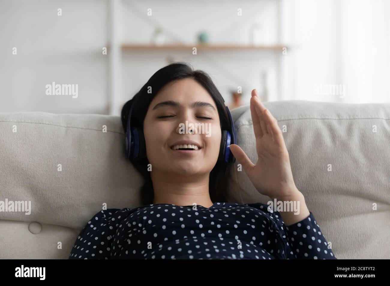 Happy Vietnamese girl listen to music in headphones Stock Photo Alamy