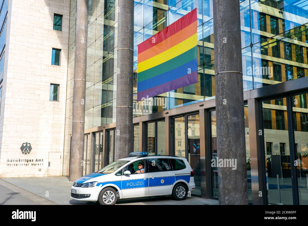 July 24th, 2020, Berlin, for the Christopher Street Day (CSD) 2020 in Berlin, the Federal Republic of Germany's Federal Department of Office was decorated with a rainbow flag as a banner. A police car stands in front of the building and guards the banner. The building is the seat of the Federal Ministry of Foreign Affairs and the Federal Minister of Foreign Affairs (Federal Minister of the Auswartenden). The rainbow flag is a form of the rainbow as a symbol. It stands for change, change and peace in numerous cultures around the world, and is seen as a sign of tolerance and acceptance, the dive Stock Photo