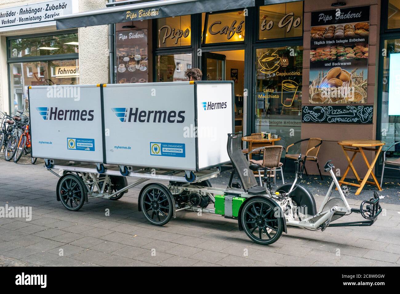 Berlin, Deutschland. 24th July, 2020. 24.07.2020, Berlin, a large cargo  bike from Hermes Paketdienst with two transport boxes, three axles and six  wheels is parked in the goalstrasse on the sidewalk. With