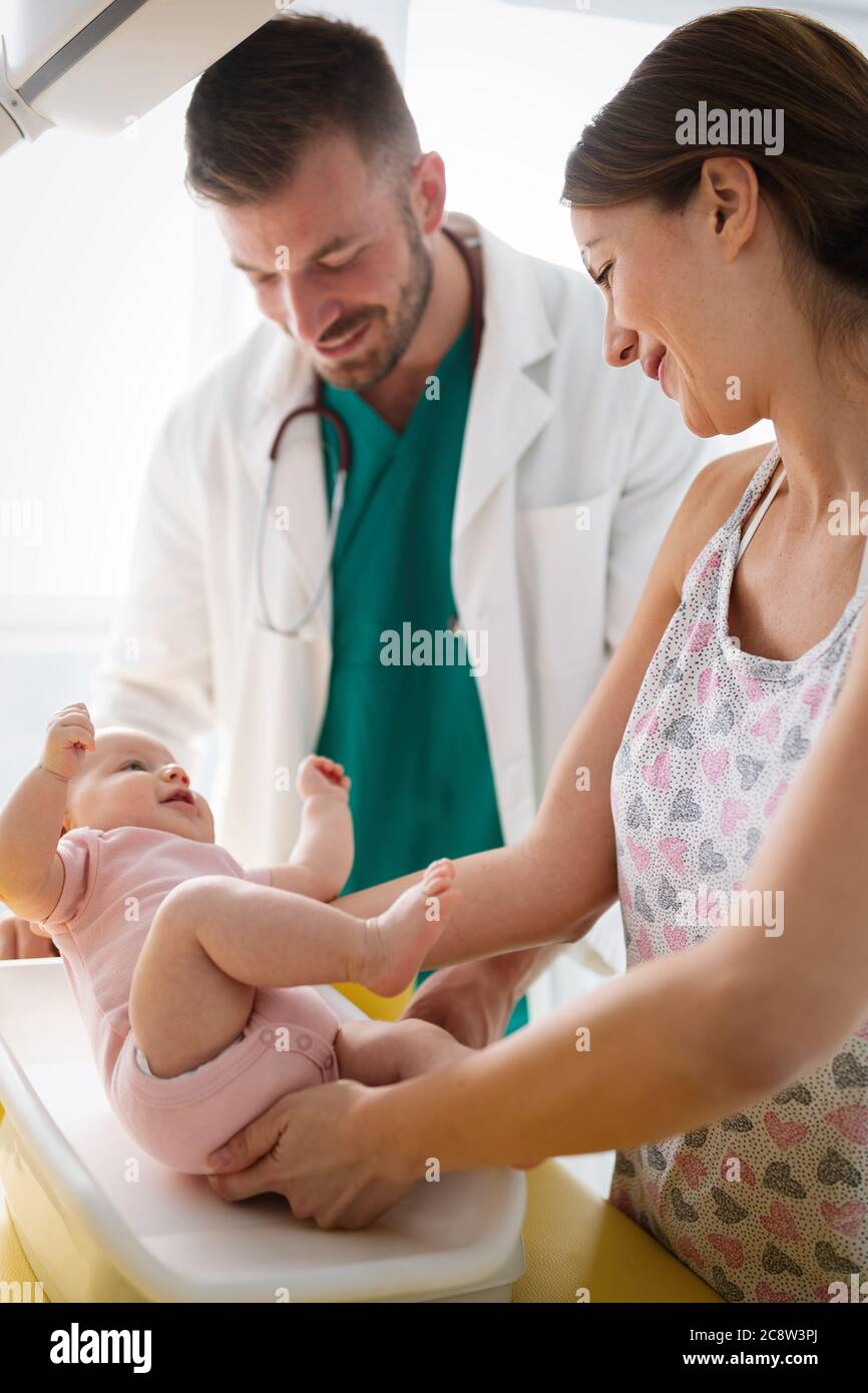 Happy beautiful mother and little baby on medical examination in pediatrician office Stock Photo