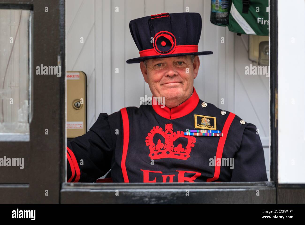 A Yeoman Warder also known as Beefeater at the Tower of London number 7 Tower Green haunted house,, England, UK Stock Photo