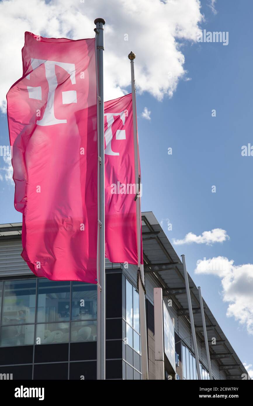 Magenta Flags with the logo of Deutsche Telekom AG in front o Stock Photo