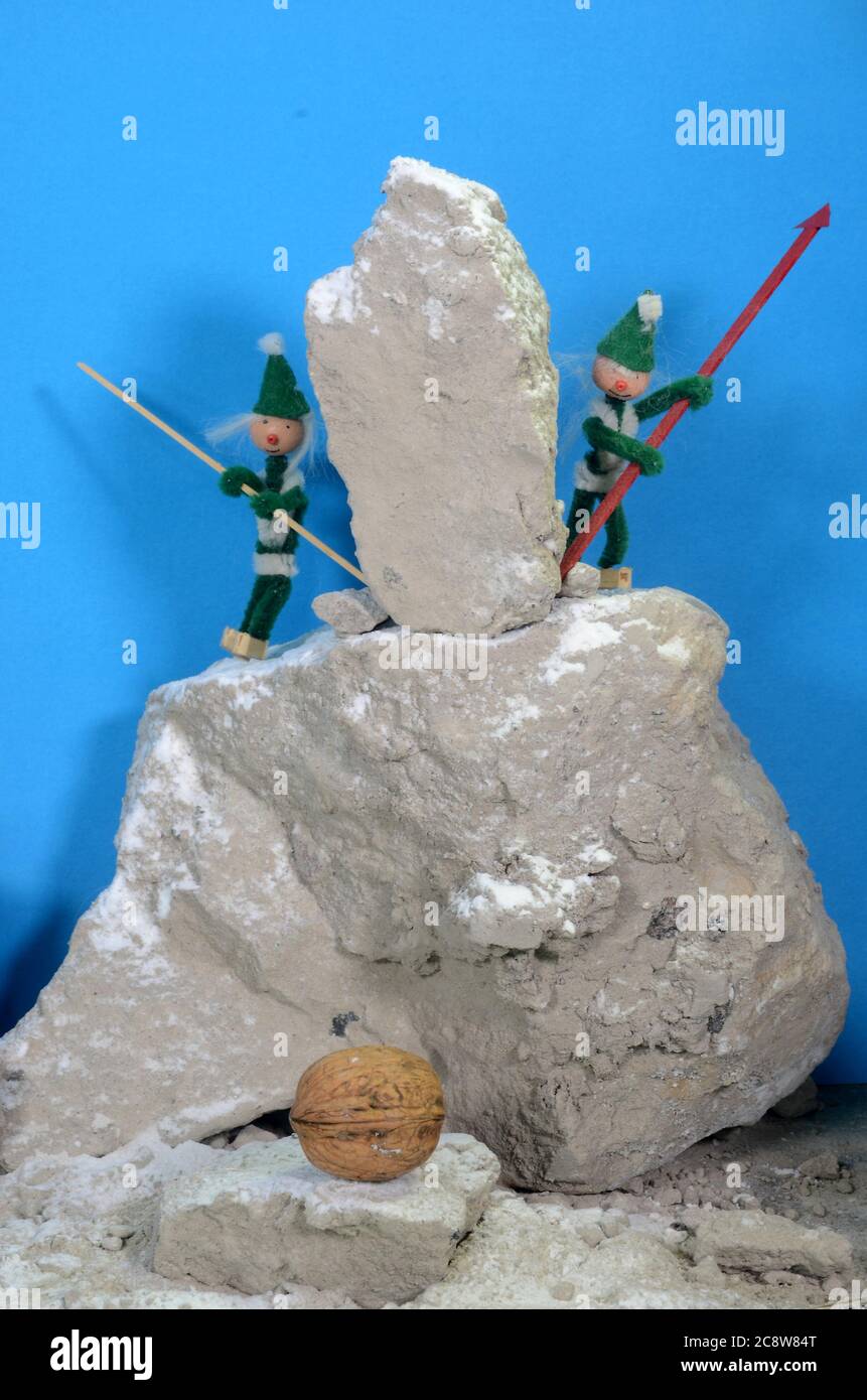 Pixie gang breaks a rock down in the hope that it will be able to break a walnut. Stock Photo