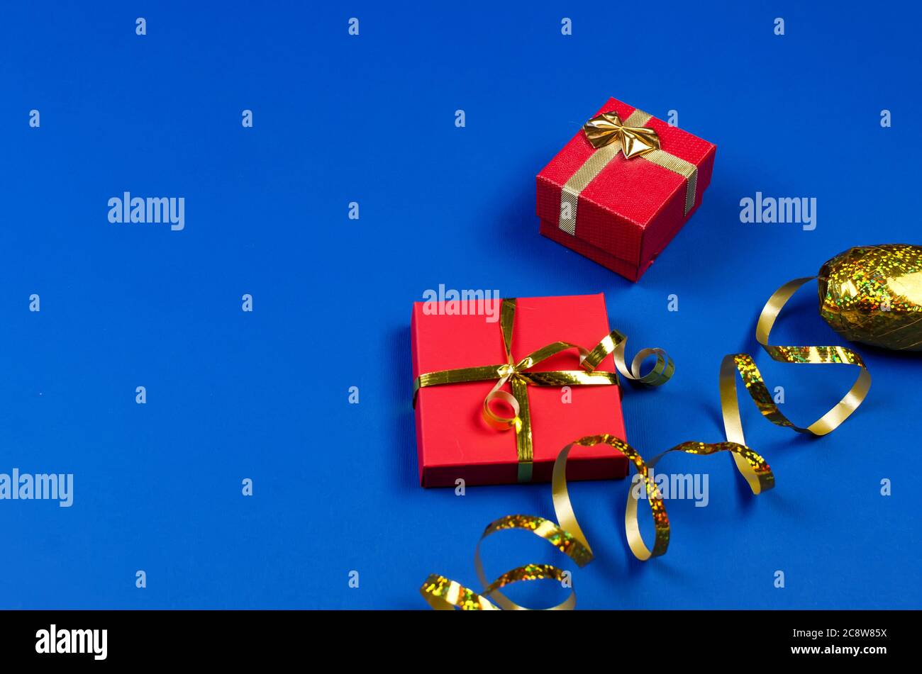 two red gift boxes on blue background. Stock Photo