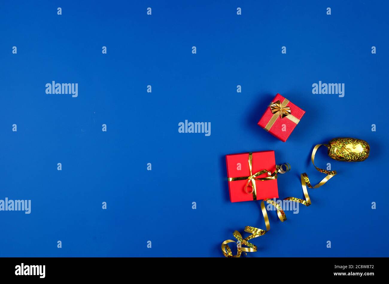 two red gift boxes on blue background. Stock Photo