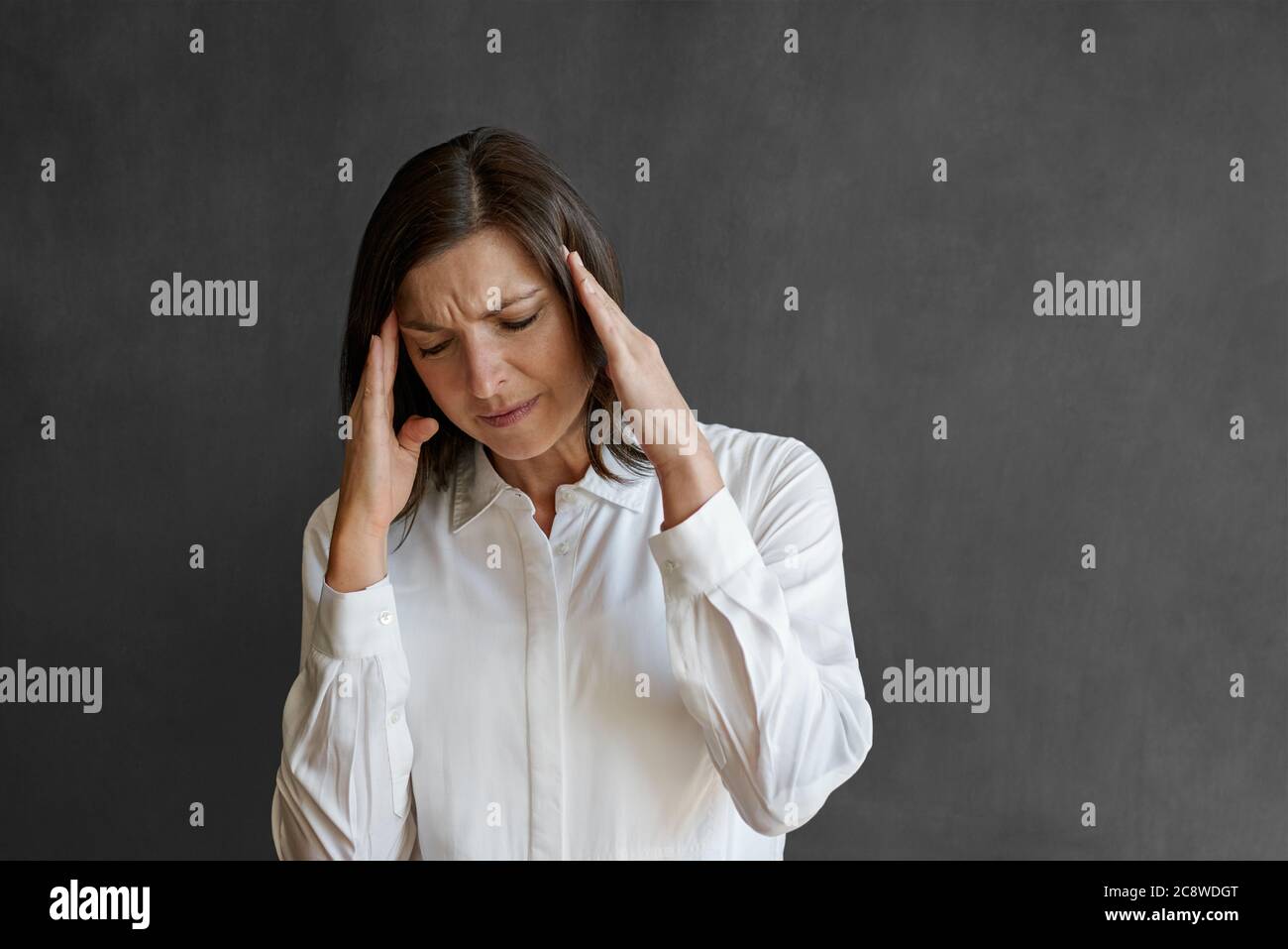 Woman fingers on temples hi-res stock photography and images - Alamy