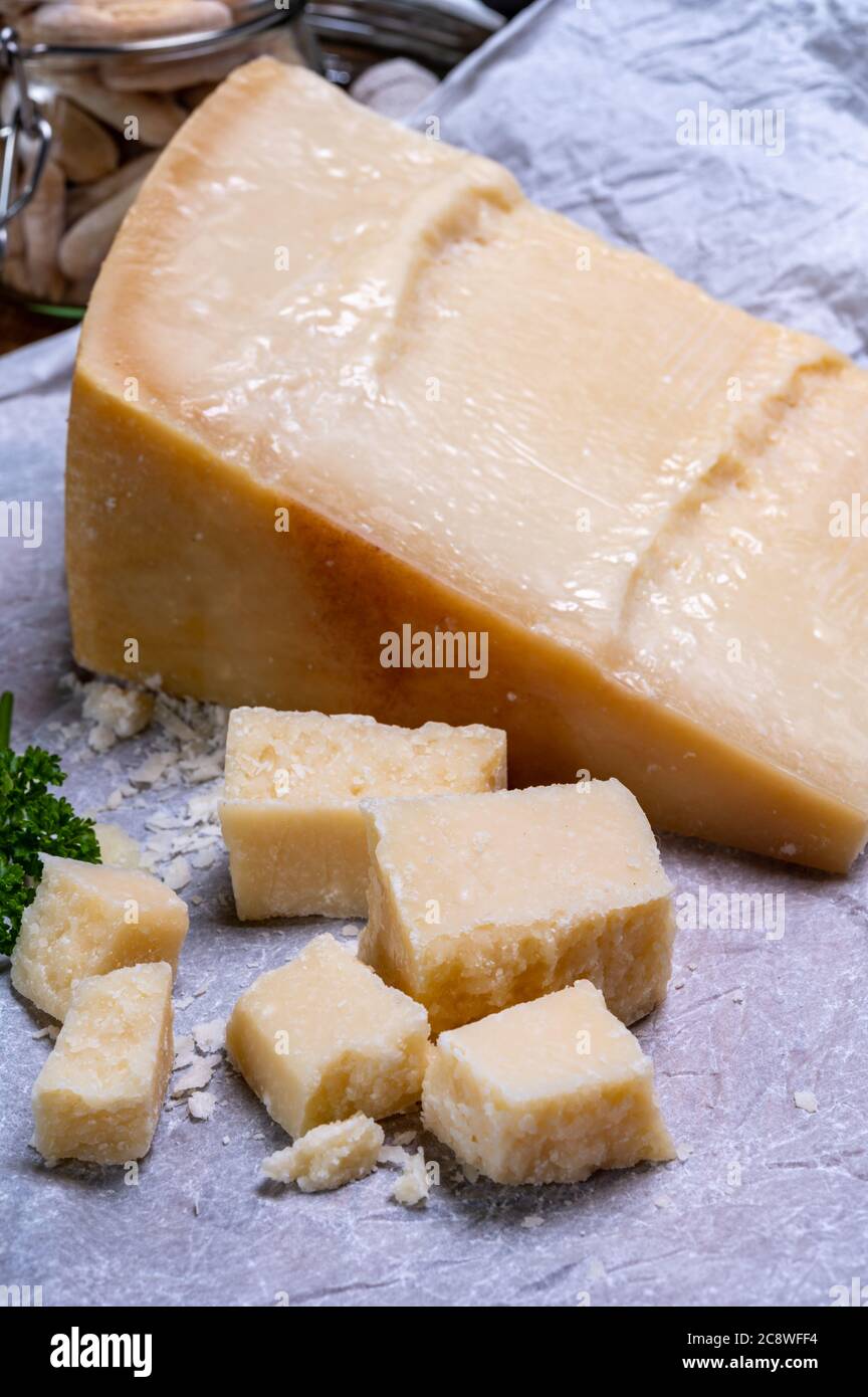 Big wedge of parmigianoreggiano parmesan hard Italian cheese made from cow milk or Grana Padano