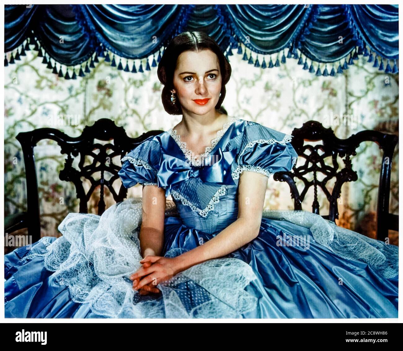Olivia de Havilland (1916-2020) playing Melanie Hamilton in Gone with the Wind (1939) an epic historical romance film adapted from Margaret Mitchell's 1936 novel and directed by Victor Fleming and George Cukor. Olivia de Havilland was one of the leading movie stars during the golden age of Classical Hollywood and appeared in 49 feature films before retiring in 1988. Stock Photo