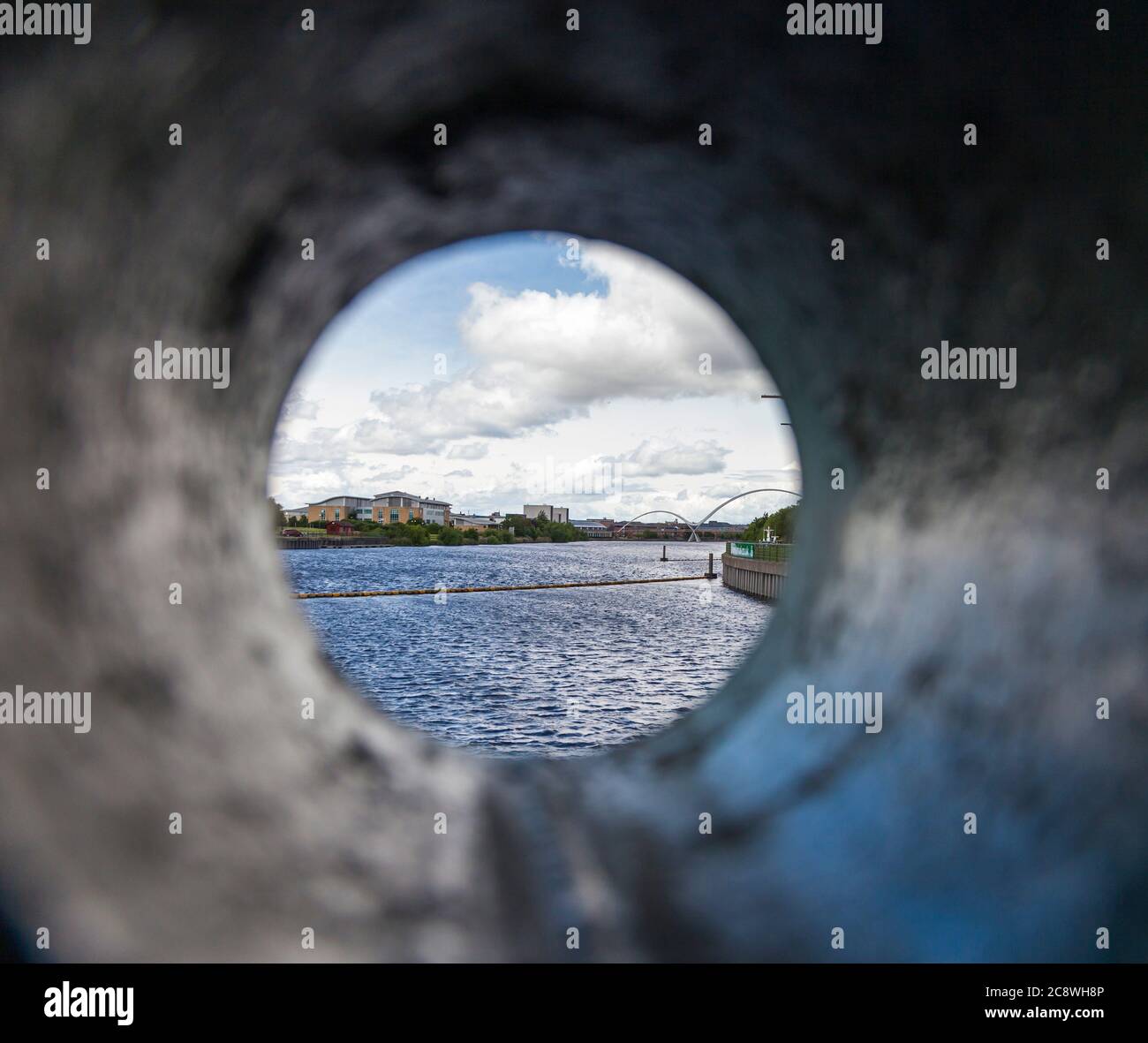 A view of the Infinity Bridge area from a cylindrical pipe at the Tees Barrage,Stockton on Tees,England UK Stock Photo