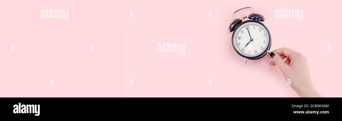 Creative Banner Morning Time Emotions Concept Top View Of Woman Hand Holding Black Vintage Alarm Clock Pastel Millennial Pink Color Paper Background W Stock Photo Alamy
