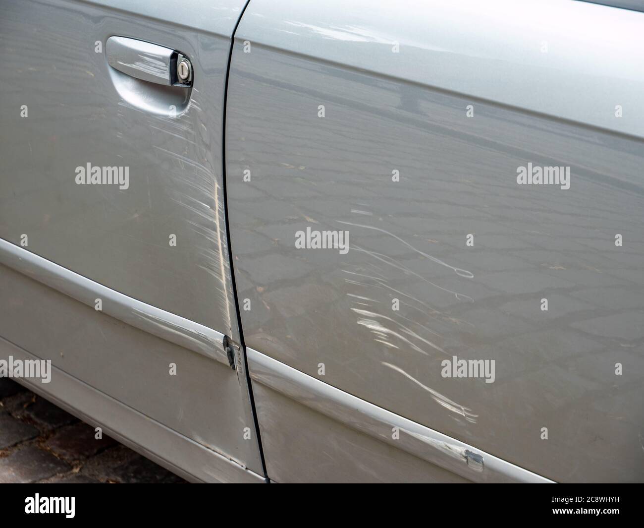 car door detail with scratches in the paint Stock Photo Alamy
