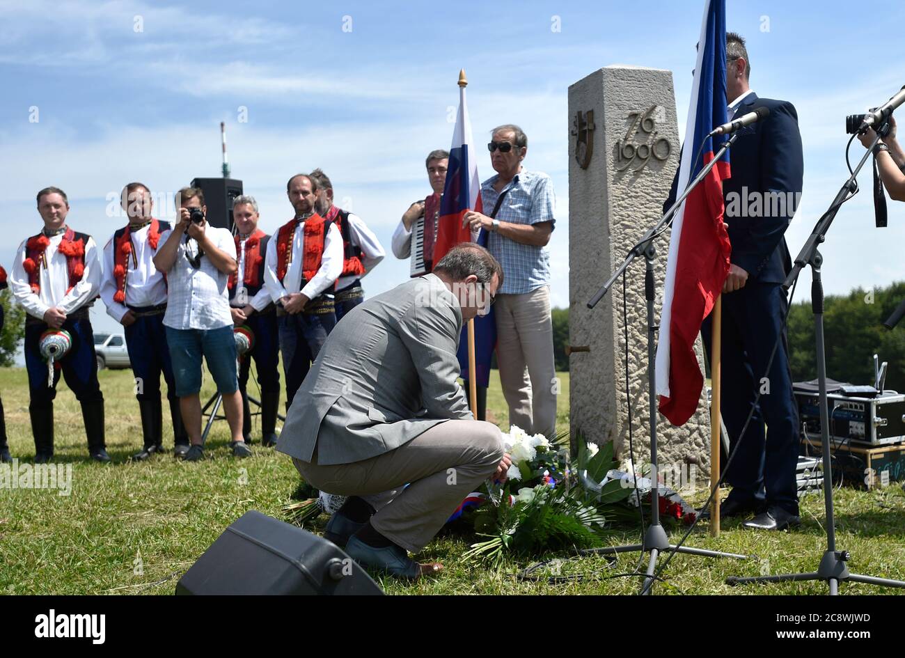 Strani, Czech Republic. 26th July, 2020. Uherske Hradiste Mayor Stanislav Blaha lays flowers to a memorial during the commemorative meeting of brotherhood of Czechs and Slovaks in limited form over coronavirus epidemiological situation took place at memorial on Velka Javorina peak, White Carpathian Mountains, July 26, 2020. Credit: Dalibor Gluck/CTK Photo/Alamy Live News Stock Photo