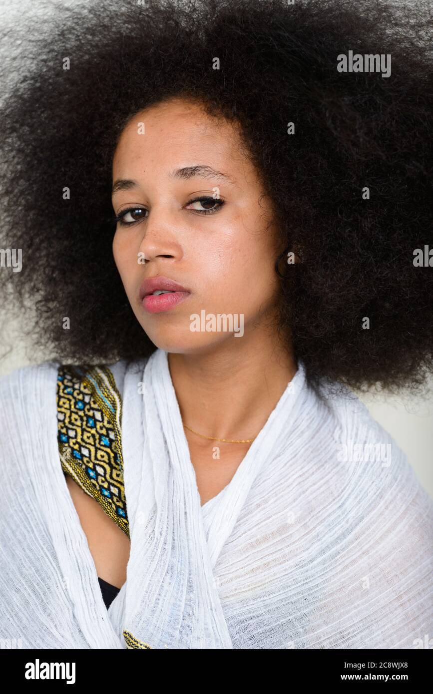 Portrait of young beautiful African woman with Afro hair in traditional ...