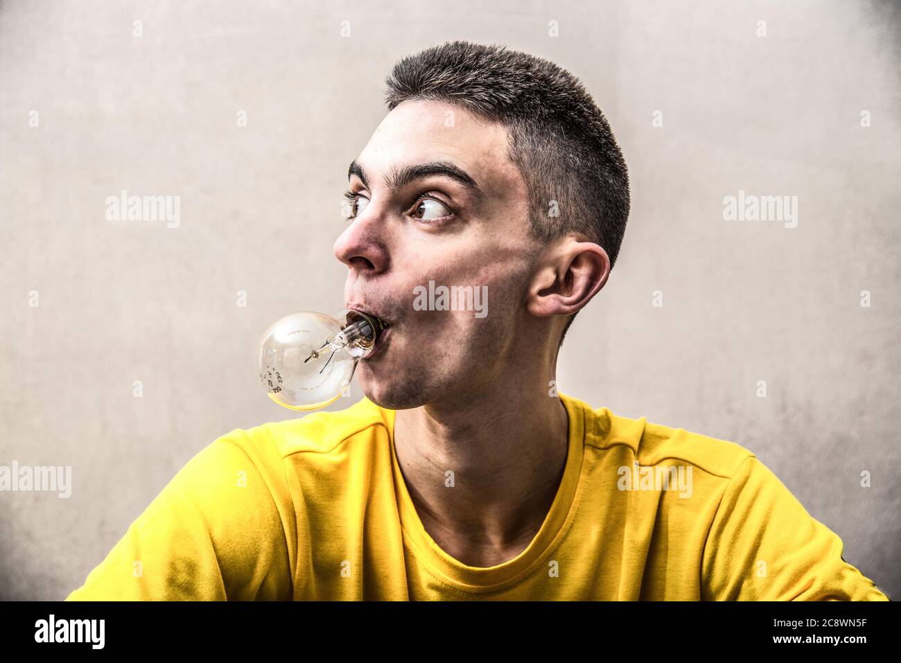 a Boy with a light bulb in his mouth Stock Photo Alamy