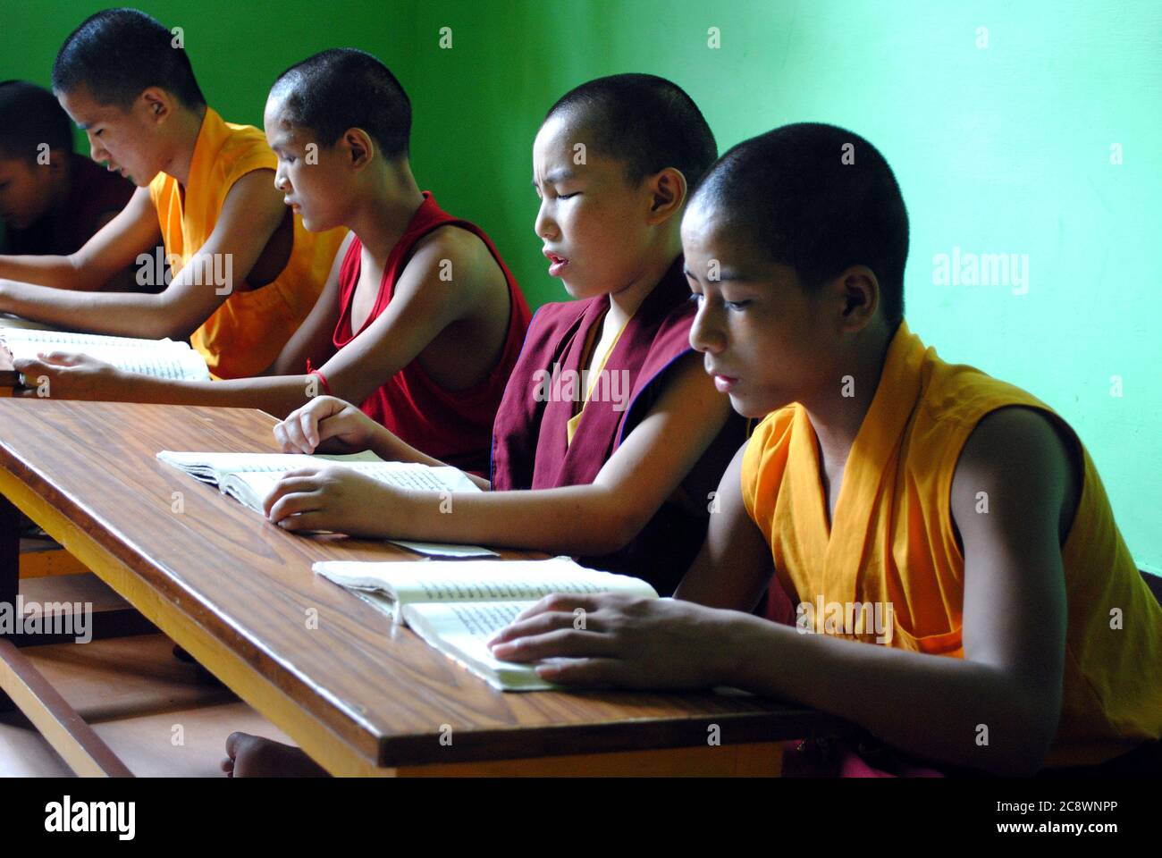 The Buddhist children are reading book in their classroom at Sarnath, Varanasi, India. Stock Photo