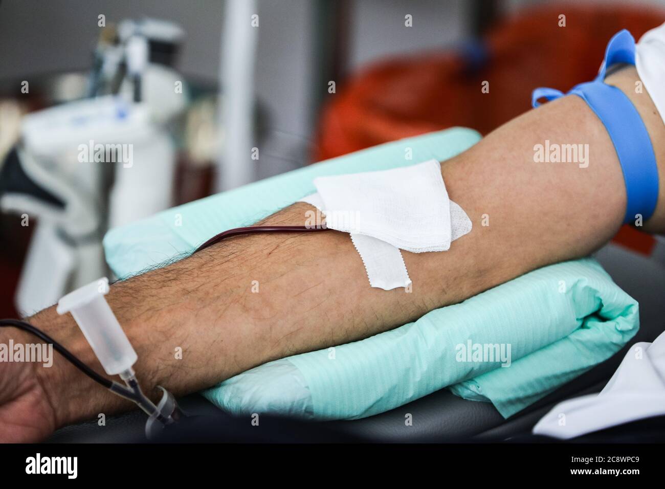 A blood donor's arm is seen during blood collecting in a laboratory.  The regional blood donation station in Kraków is the most important facility of Stock Photo