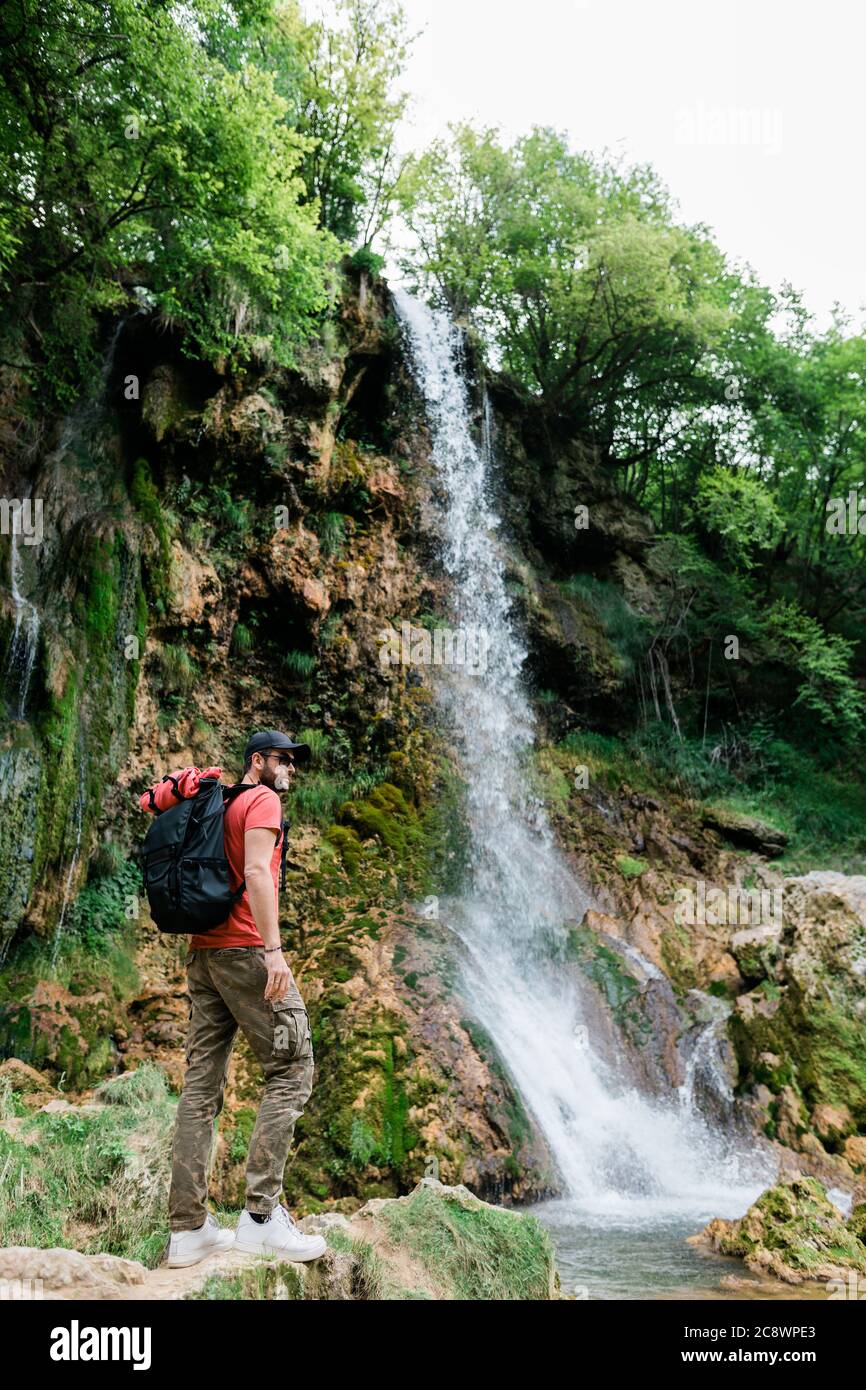 Young male nature explorer by the waterfalls Stock Photo