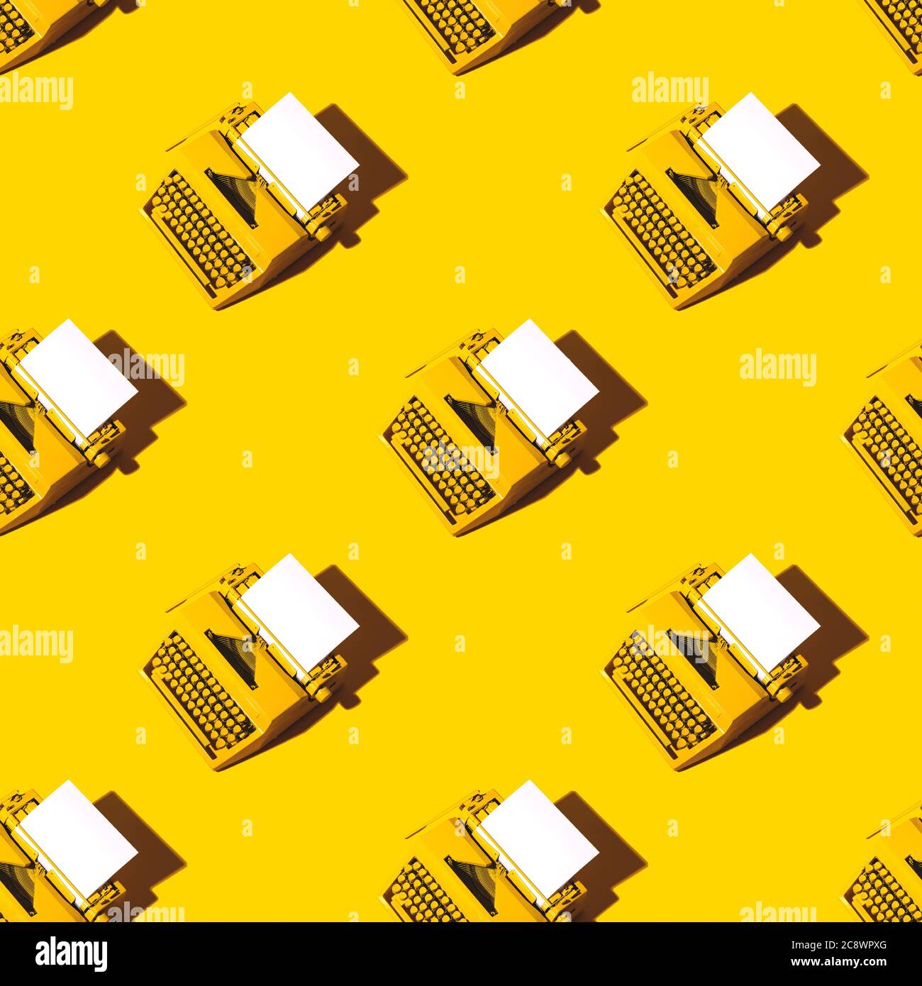 Yellow bright typewriter on a yellow background. Creativity concept