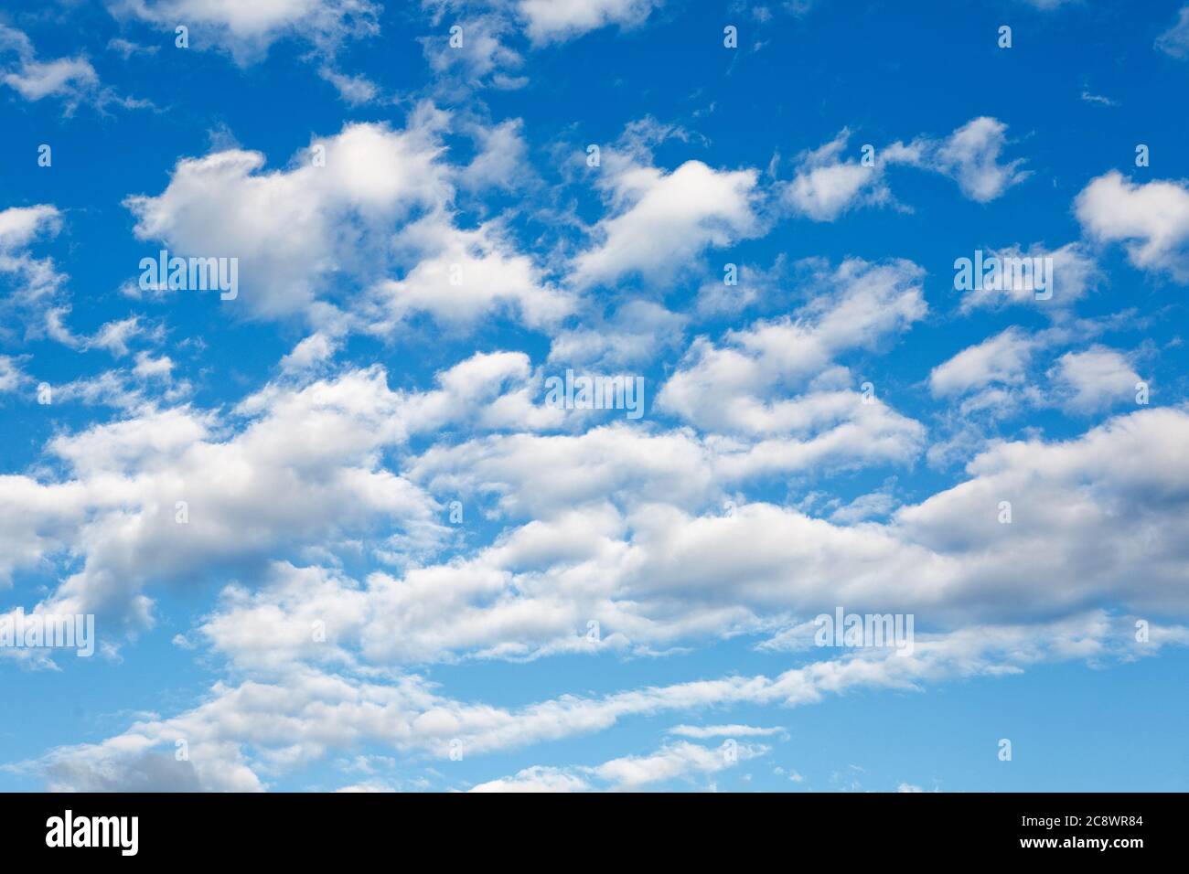 Low angle shot of a bright blue sky with white clouds Stock Photo - Alamy