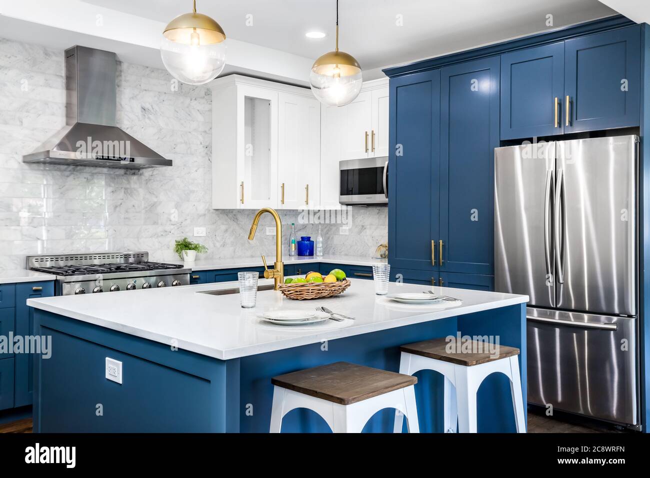 https://c8.alamy.com/comp/2C8WRFN/a-luxurious-white-and-blue-kitchen-with-gold-hardware-bosch-and-samsung-stainless-steel-appliances-and-white-marbled-granite-counter-tops-2C8WRFN.jpg