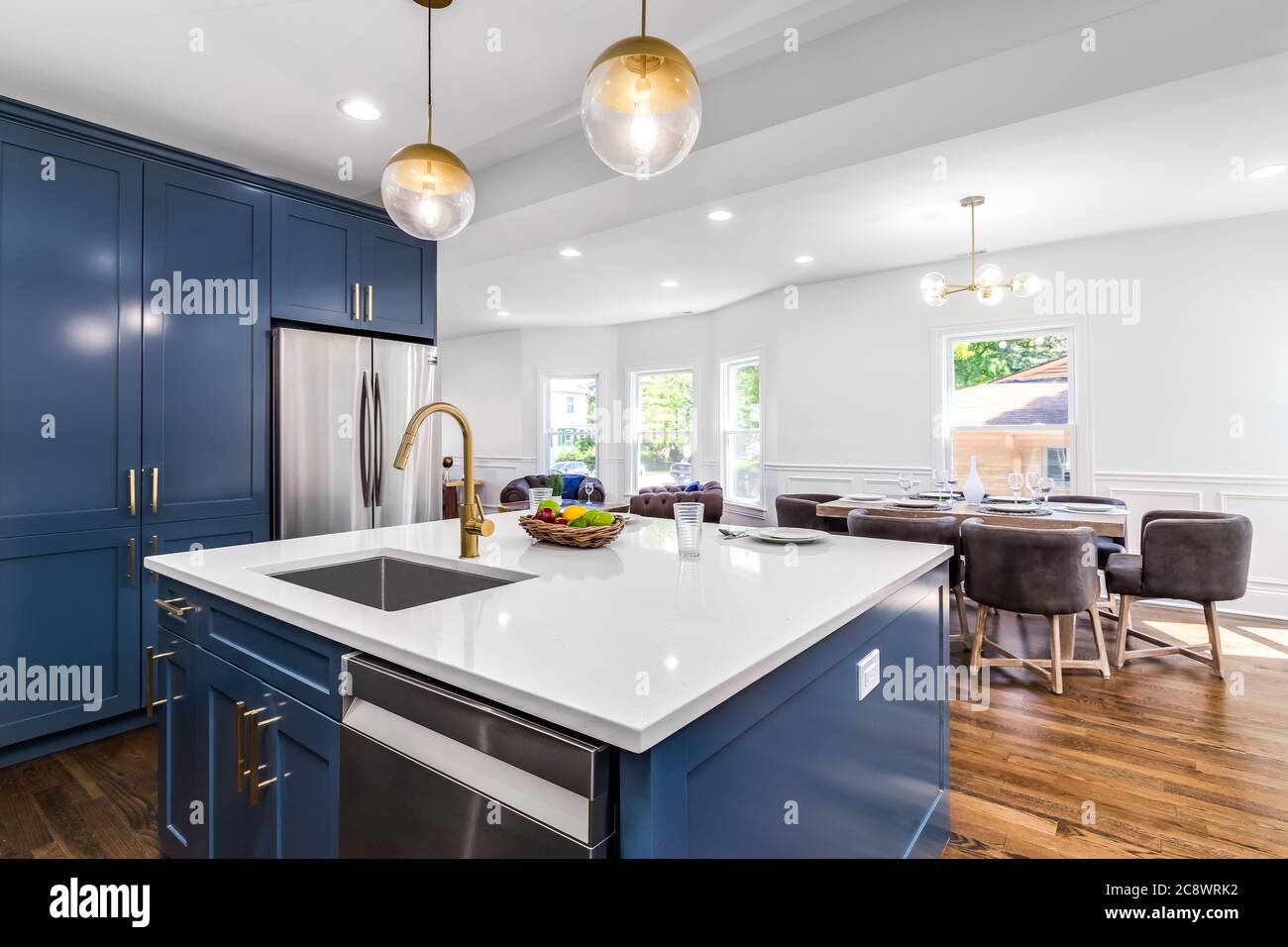 A luxurious white and blue kitchen with gold hardware, Bosch and Samsung  stainless steel appliances, and white marbled granite counter tops Stock  Photo - Alamy