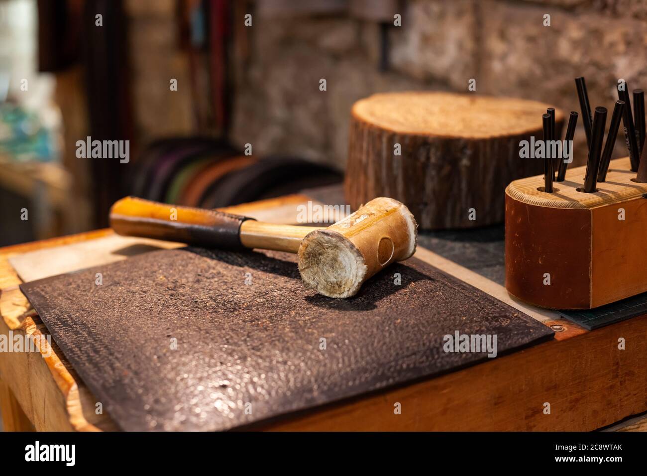 Closeup of tools of a leather craftsman in beautiful traditional workshop Stock Photo