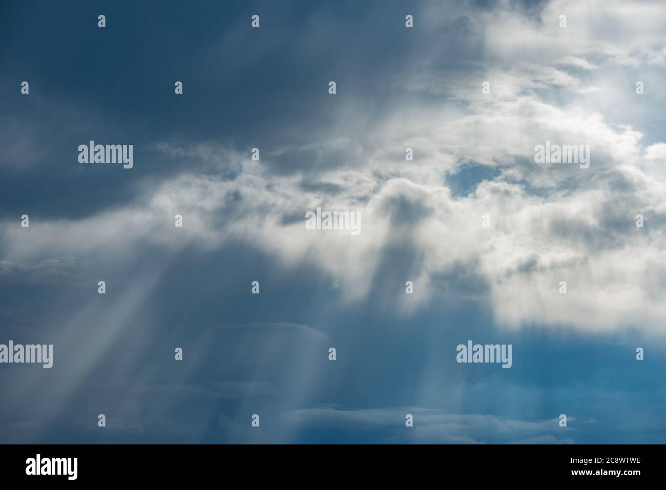 Sun rays break through the stormy clouds. Stock Photo