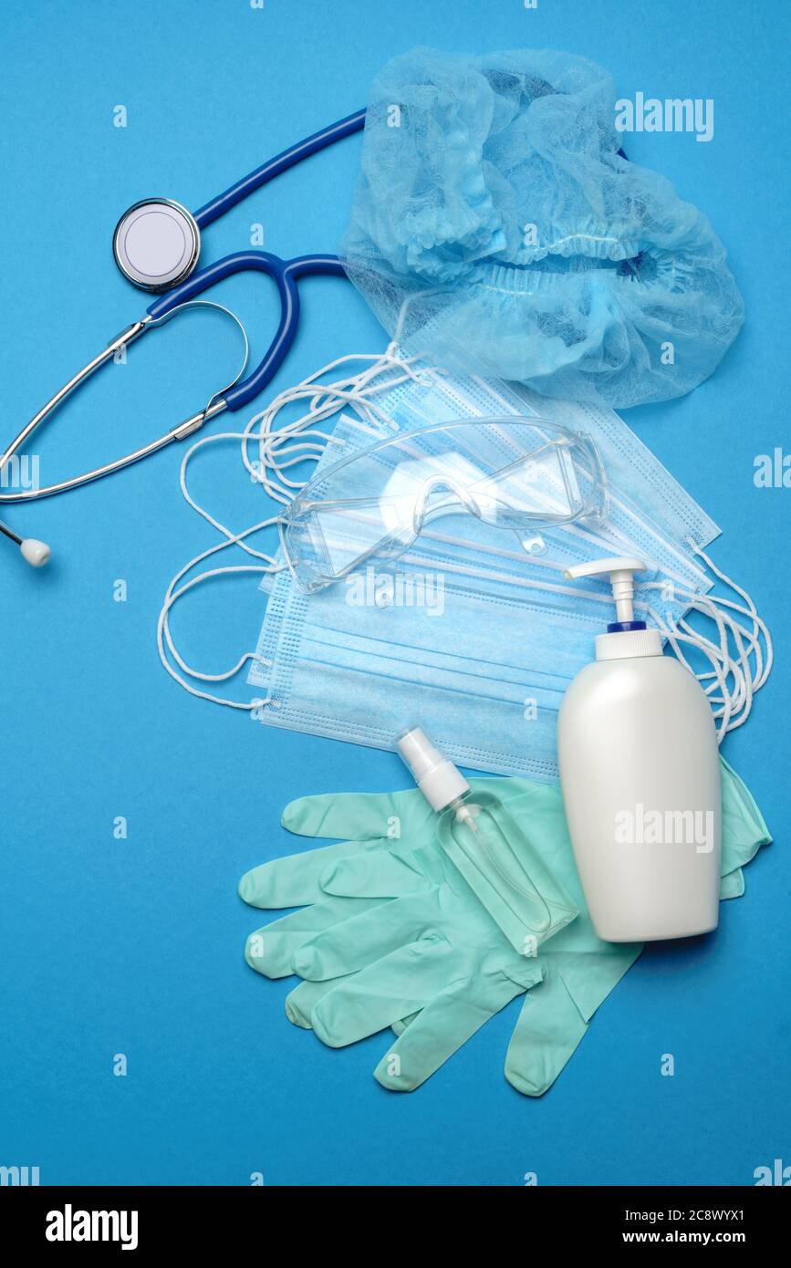 Stack of Disposable blue medical face masks, rubber latex gloves