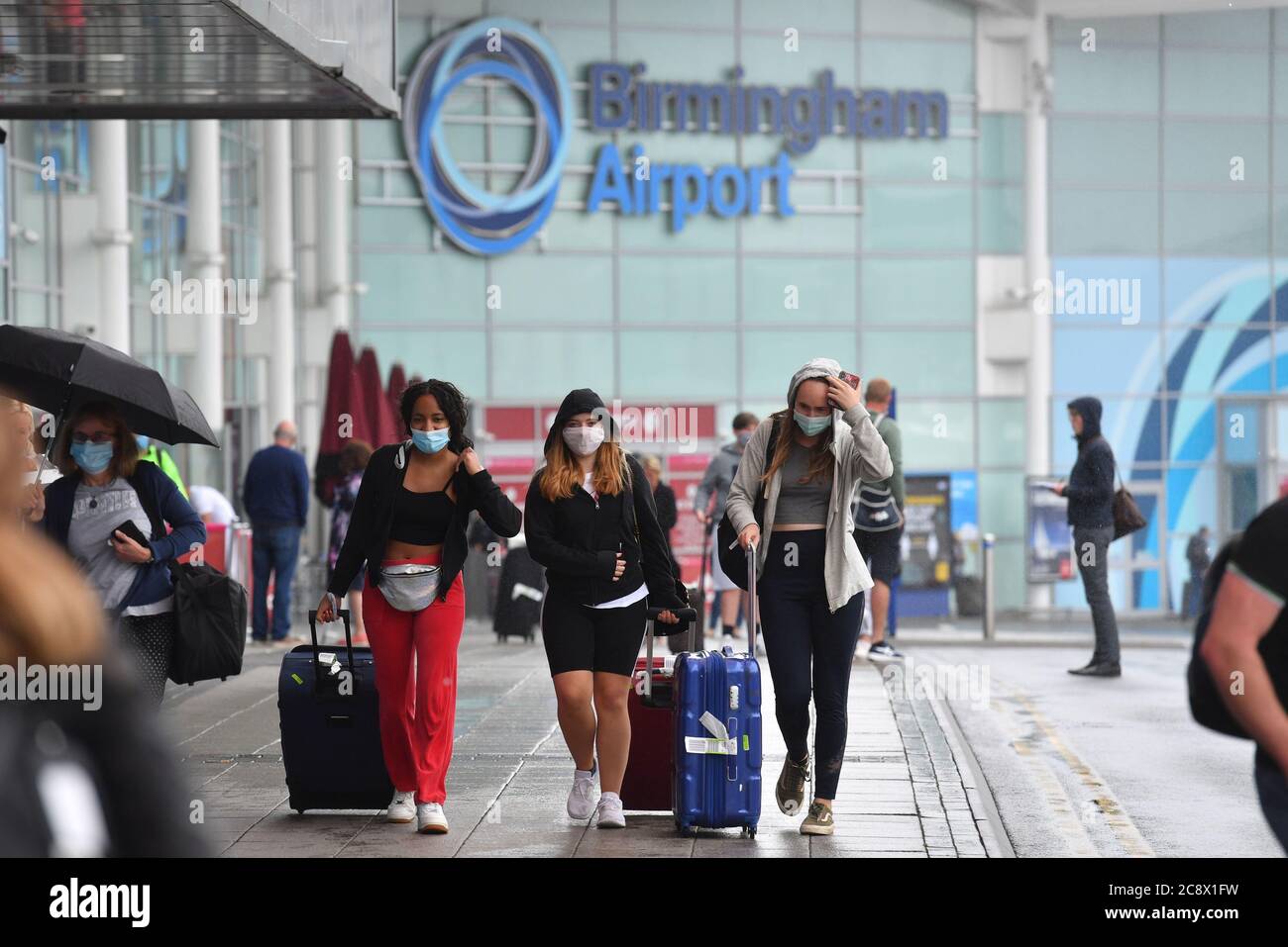 Passengers arriving at Birmingham Airport, as people arriving into England from holidays in Spain have been told they must quarantine when they return home. Stock Photo