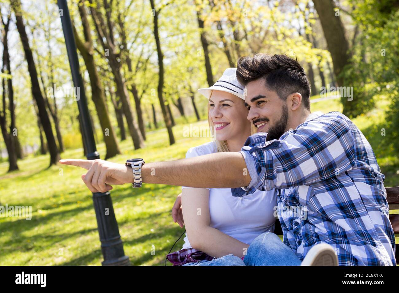 Beautiful caucasian couple sitting on a park bench Stock Photo - Alamy