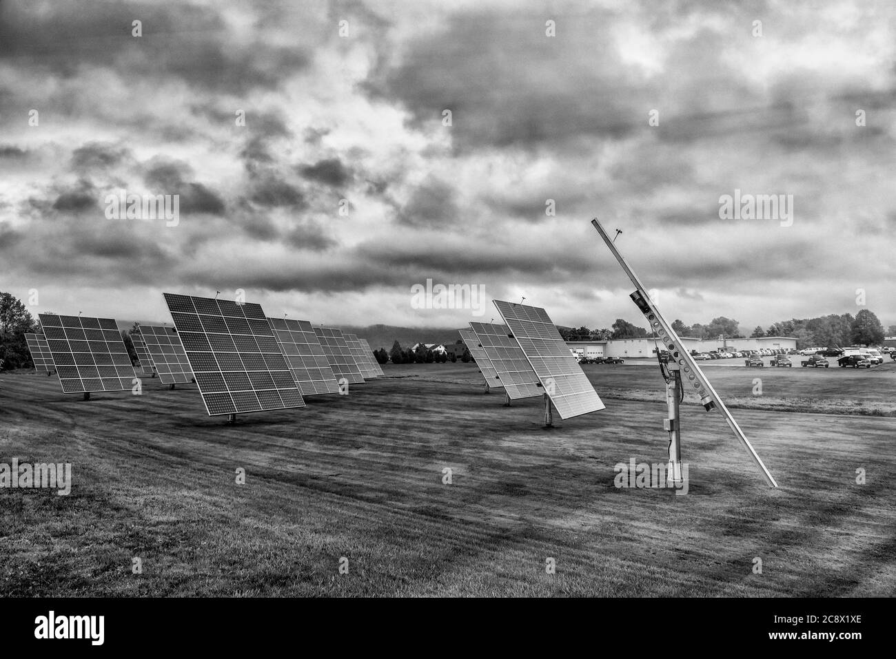 Solar panels at sunrise with cloudy sky in the countryside. Solar energy, modern electric power production technology, renewable energy concept. Envir Stock Photo