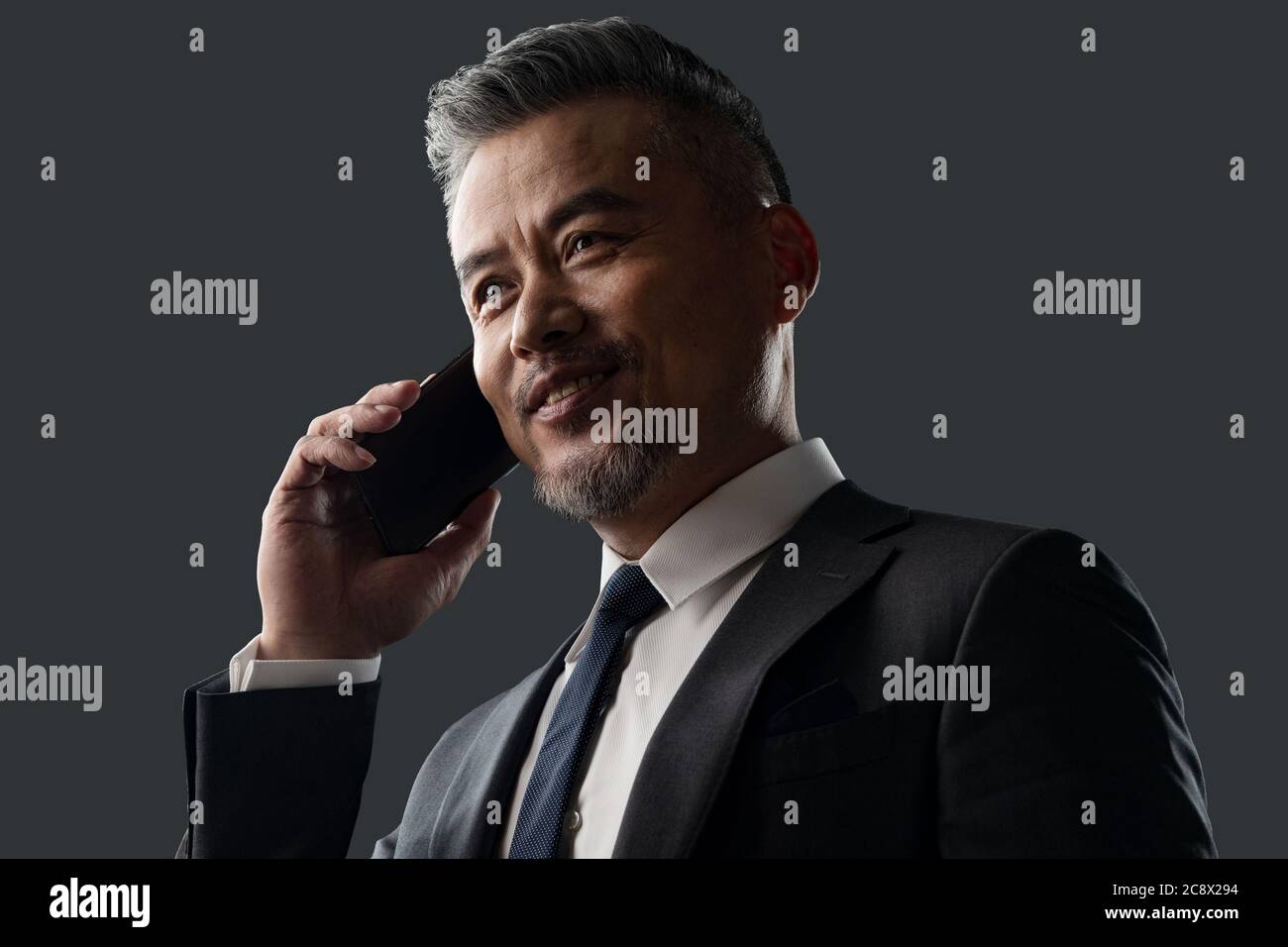 Holding a cell phone business men Stock Photo