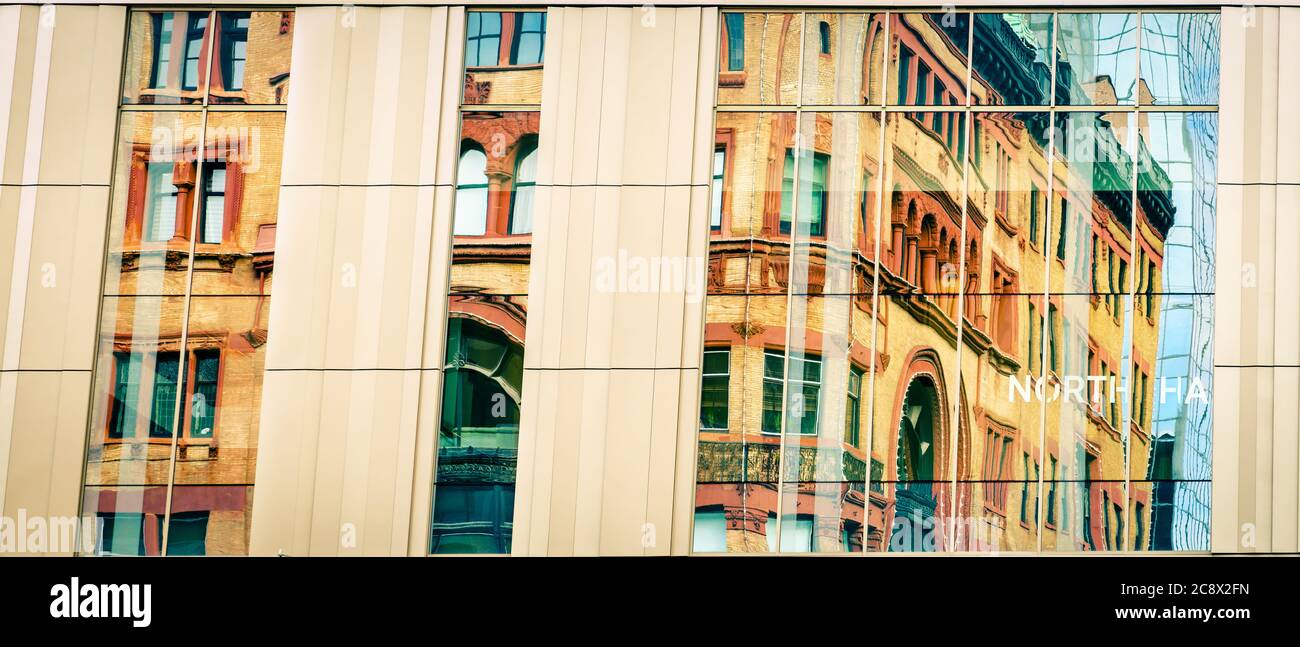An old historic building reflected in windows of Kentucky International Convention Center in Louisville, KY Stock Photo