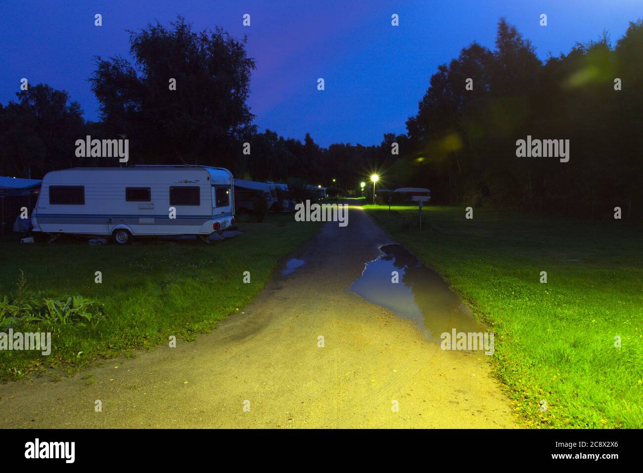 FALSTERBO, SWEDEN ON SEPTEMBER 05, 2011. Late arrive to a campsite. Driveway, main light and caravans. Editorial use. Stock Photo